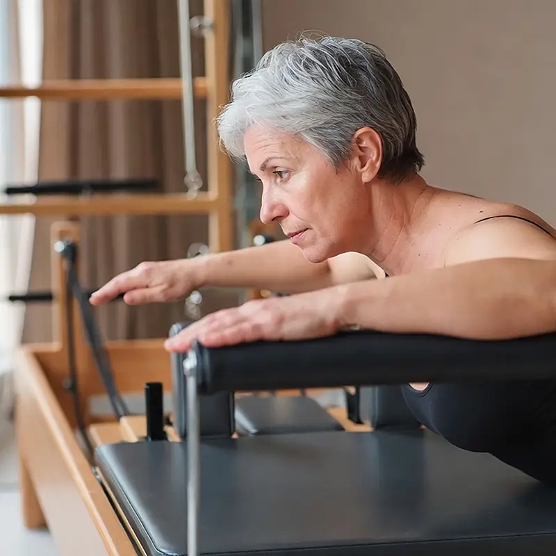 Señora haciendo pilates en centro de pilates LESSENZIA cambados de Verónica Rofrano